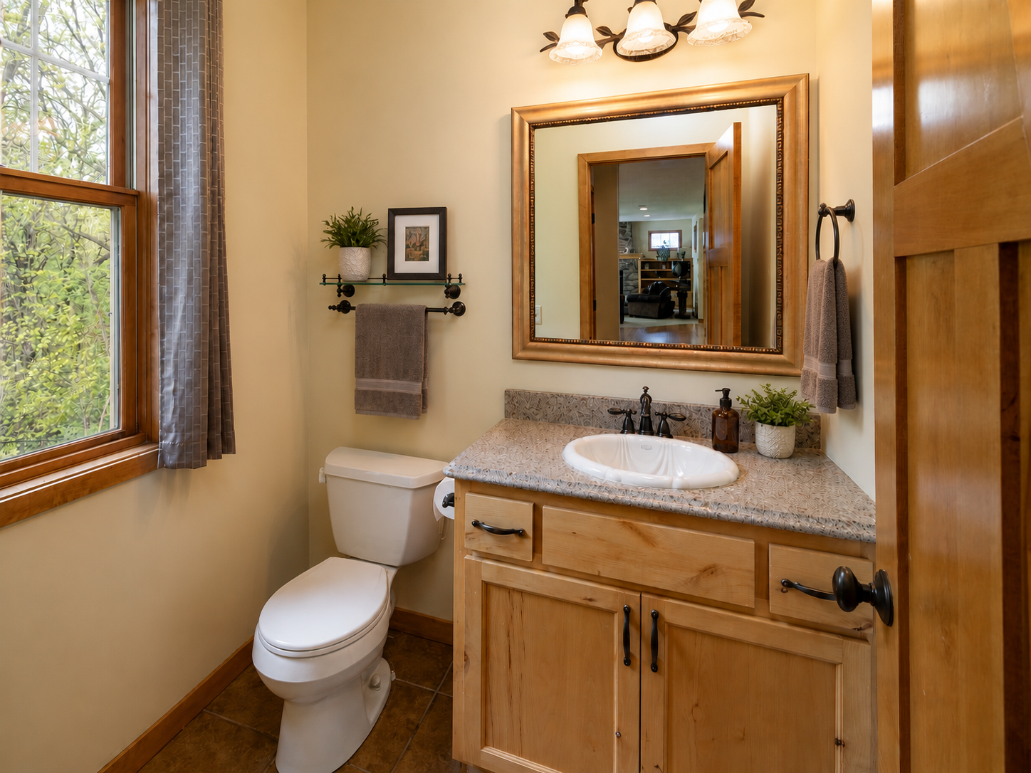Convenient 1/2 bath off mud room and garage access. *virtually stagged