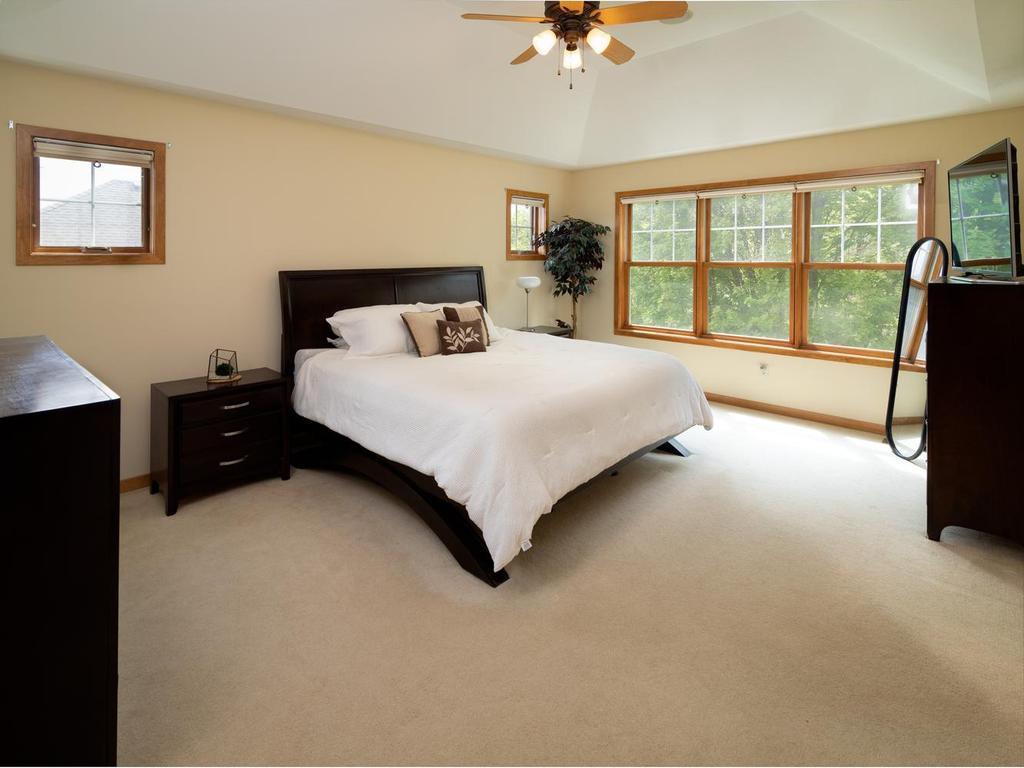 Elegant primary suite with large picture and transom windows.