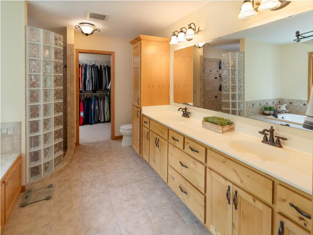 Dual sink vanity and linen cabinet.