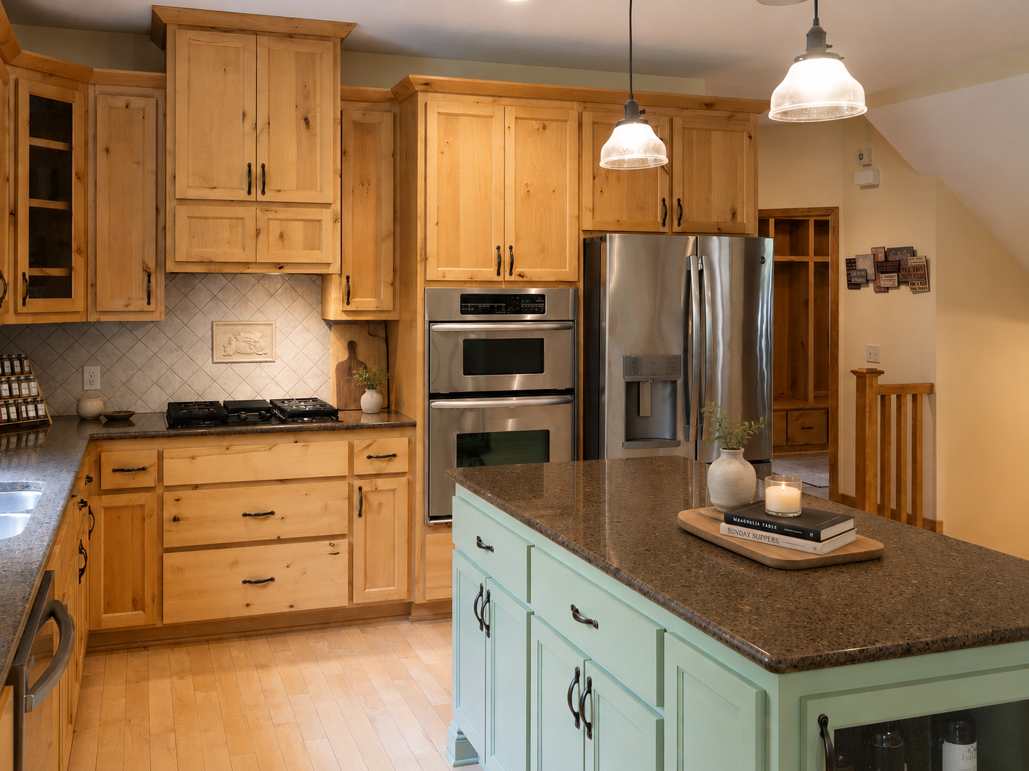 Custom tile backsplash, stainless steel appliances including gas range, wall oven/microwave, and side-by-side refrigerator.