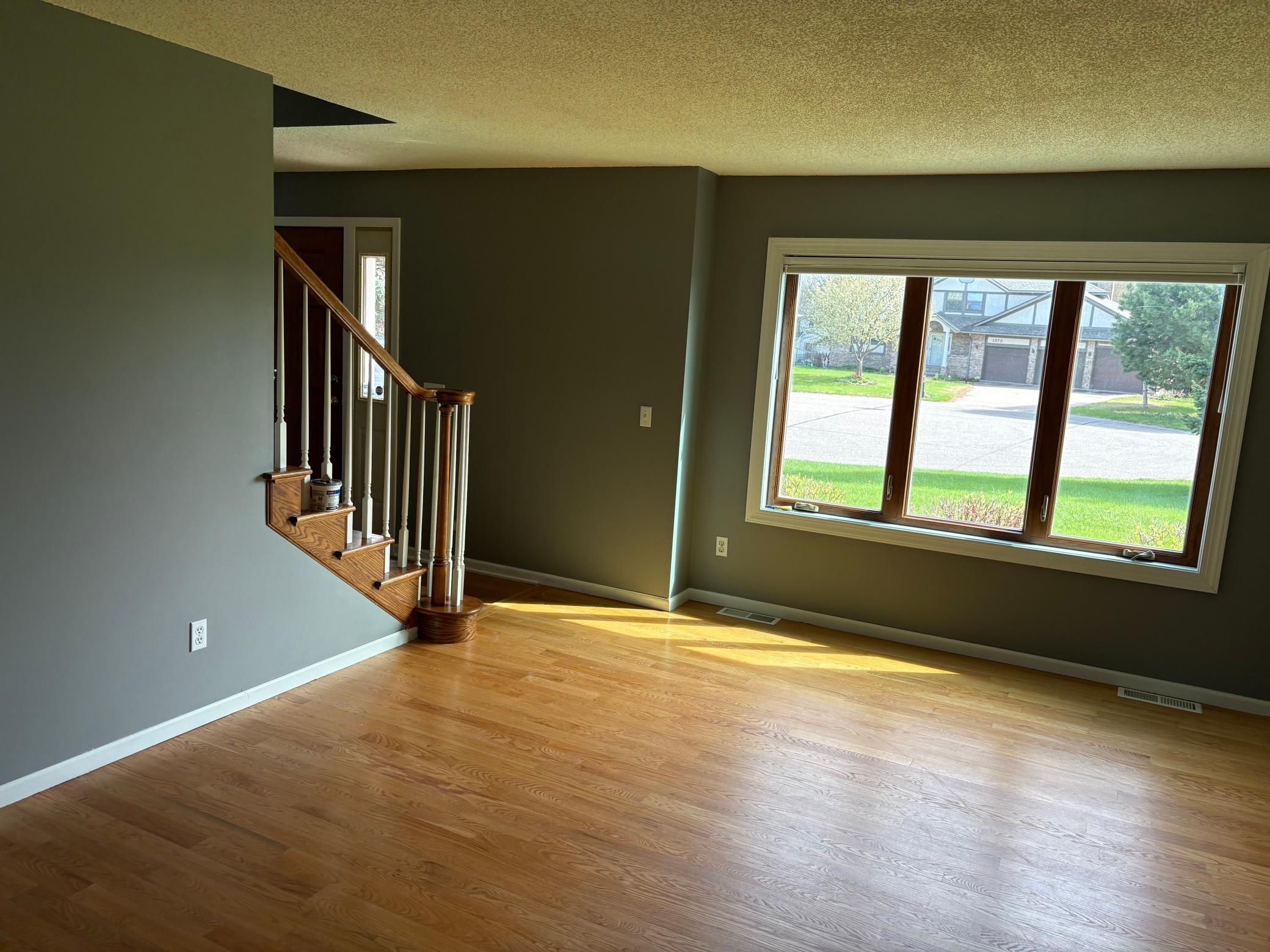 Living room has gleaming hardwood floors