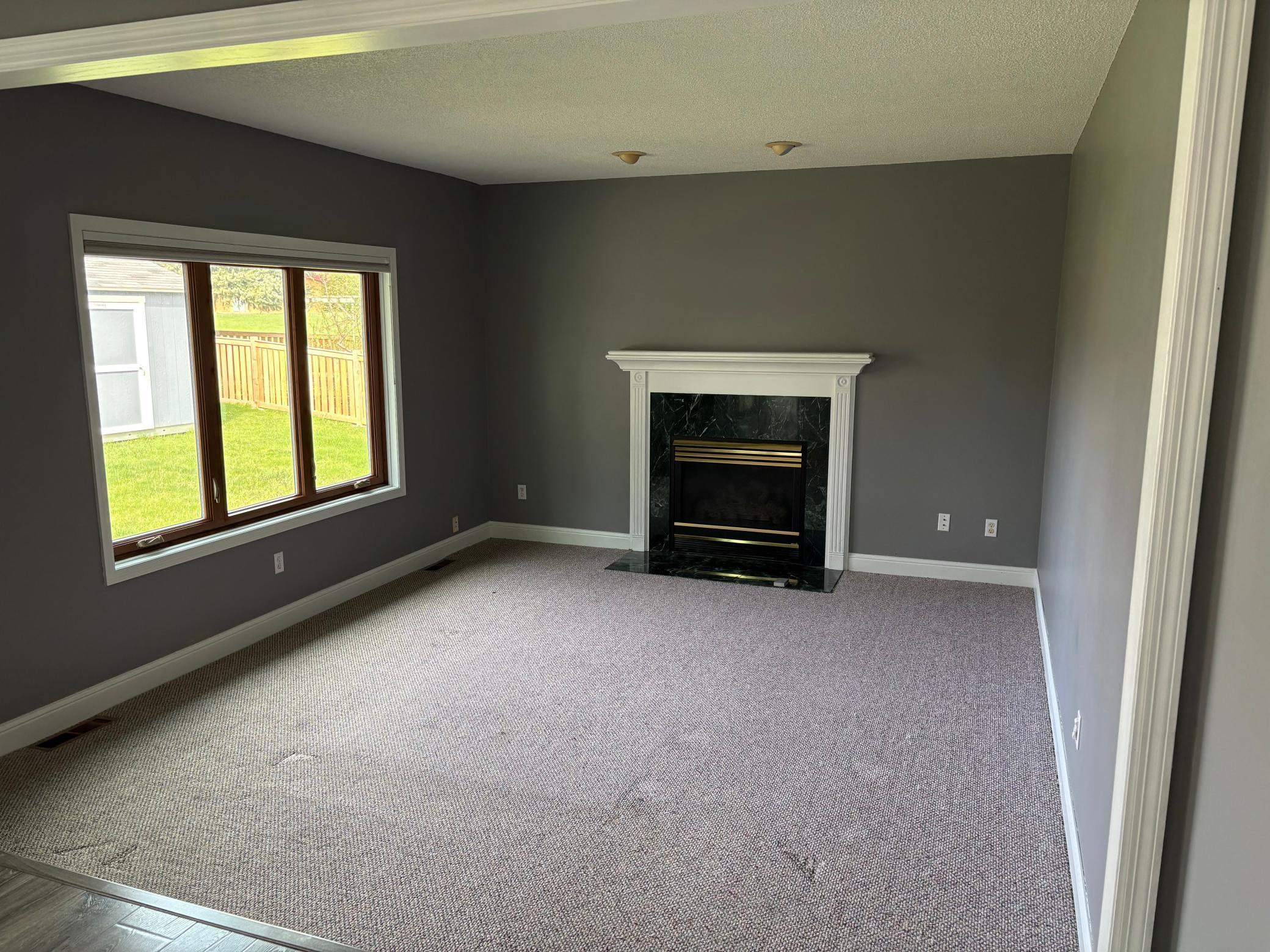 The family room has a cozy gas fireplace and lots of windows
