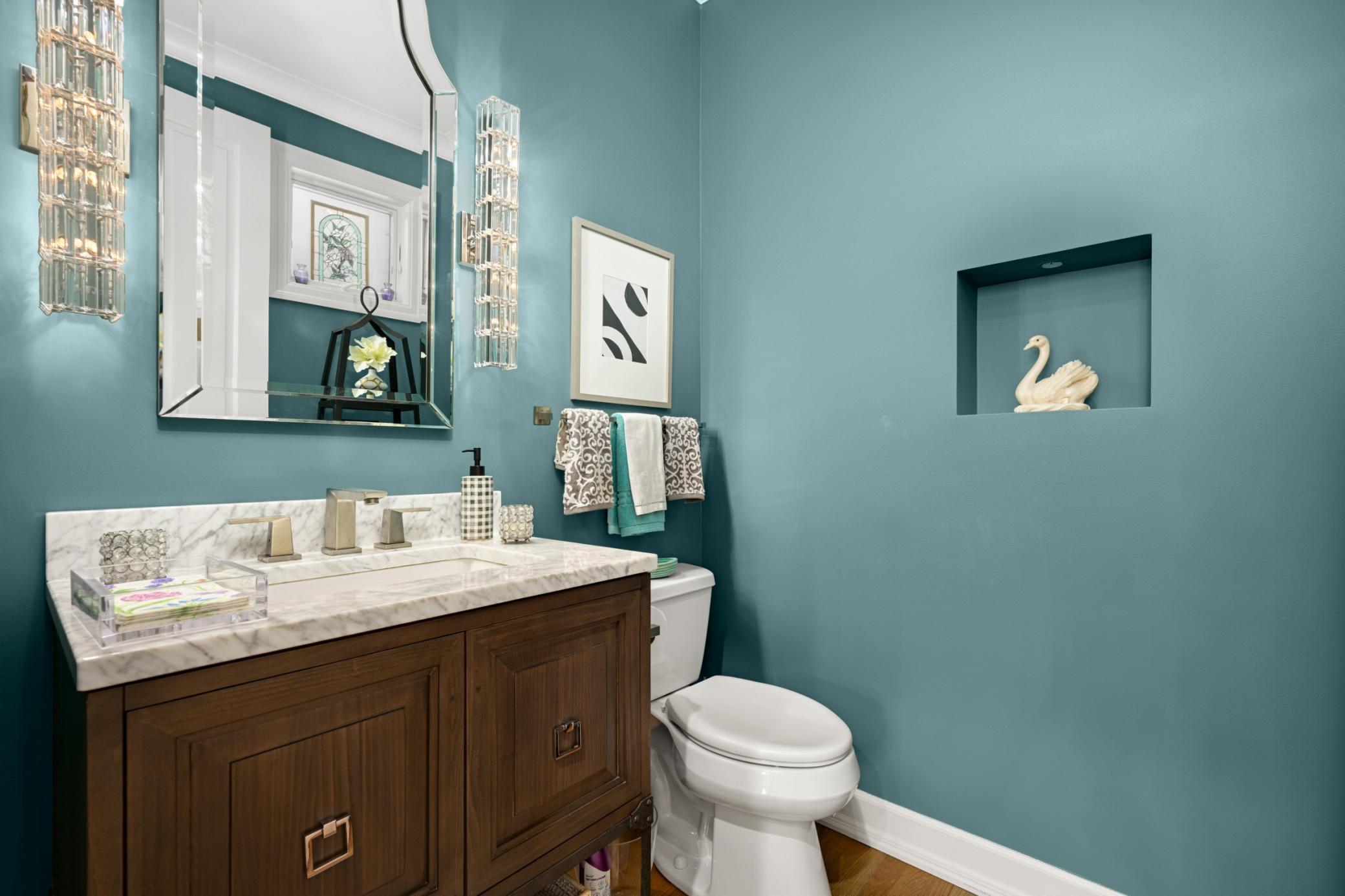 Quant main floor powder room with a lit art niche