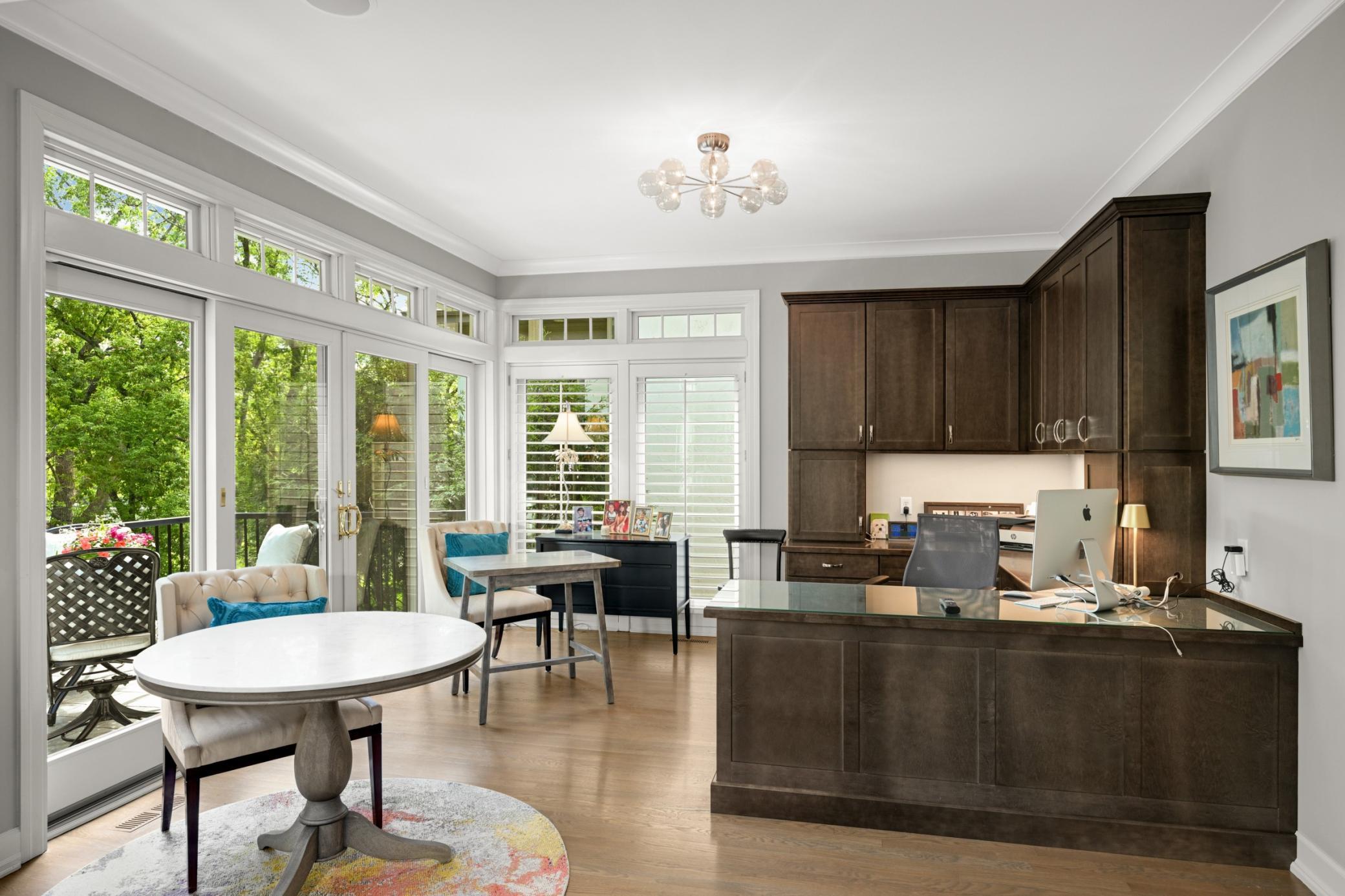 There is a spacious open study with substantial built-ins and 12’ feet of windows and sliding doors with transom windows to the lake