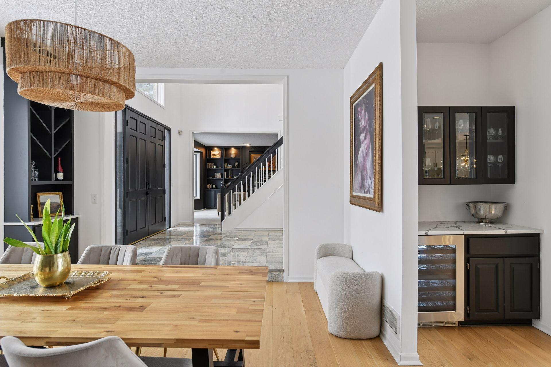 Glass-door cabinets and built-in storage create a stylish space for curated hosting, equipped with Cafe series beverage refrigerator.