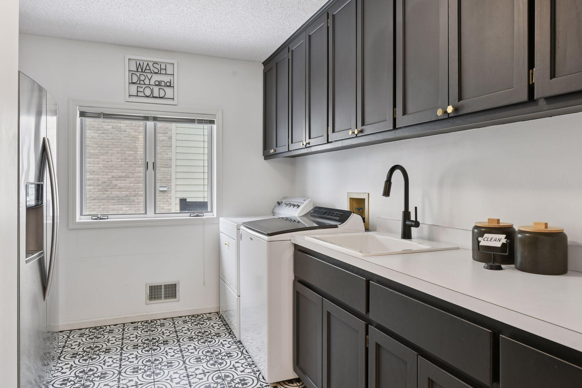 Conveniently located on the main level, this thoughtfully designed laundry space blends efficiency with elevated finishes — simplifying daily living without sacrificing style.