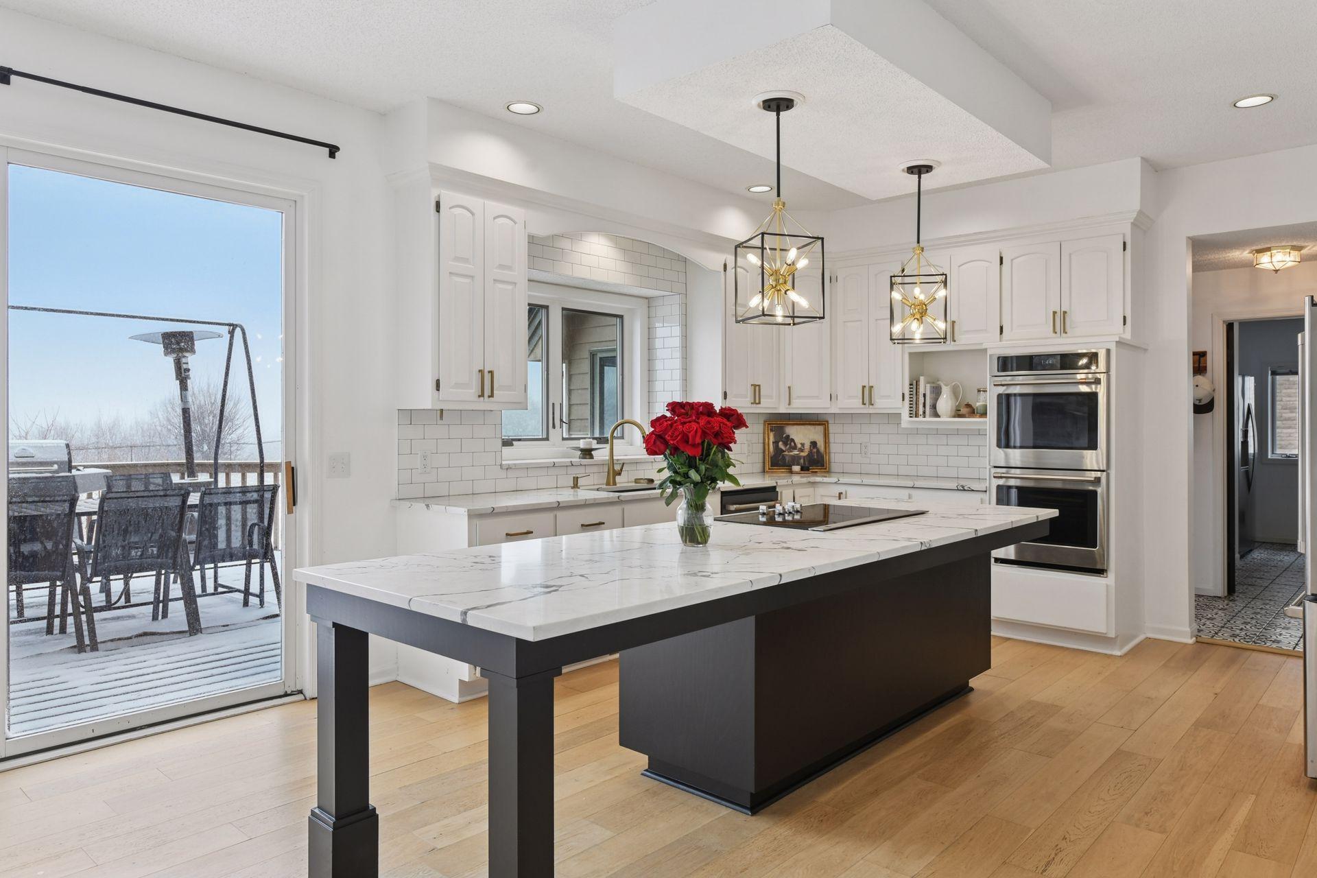 An expansive quartz island anchors the kitchen — designed for gathering, prepping, serving, and everyday connection.