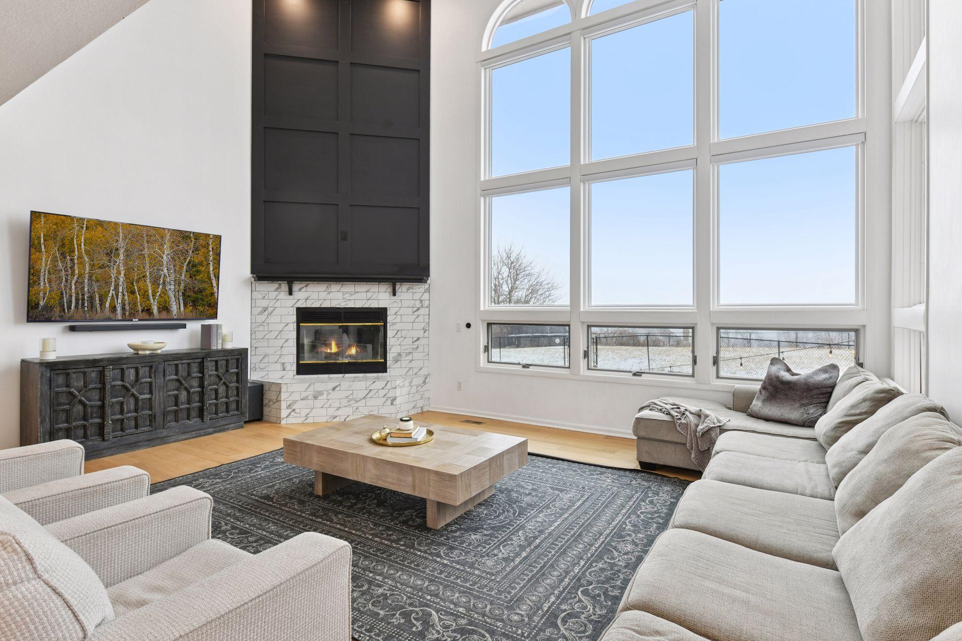 This great room is flooded with natural light and anchored by one of three wood-burning fireplaces throughout the home.