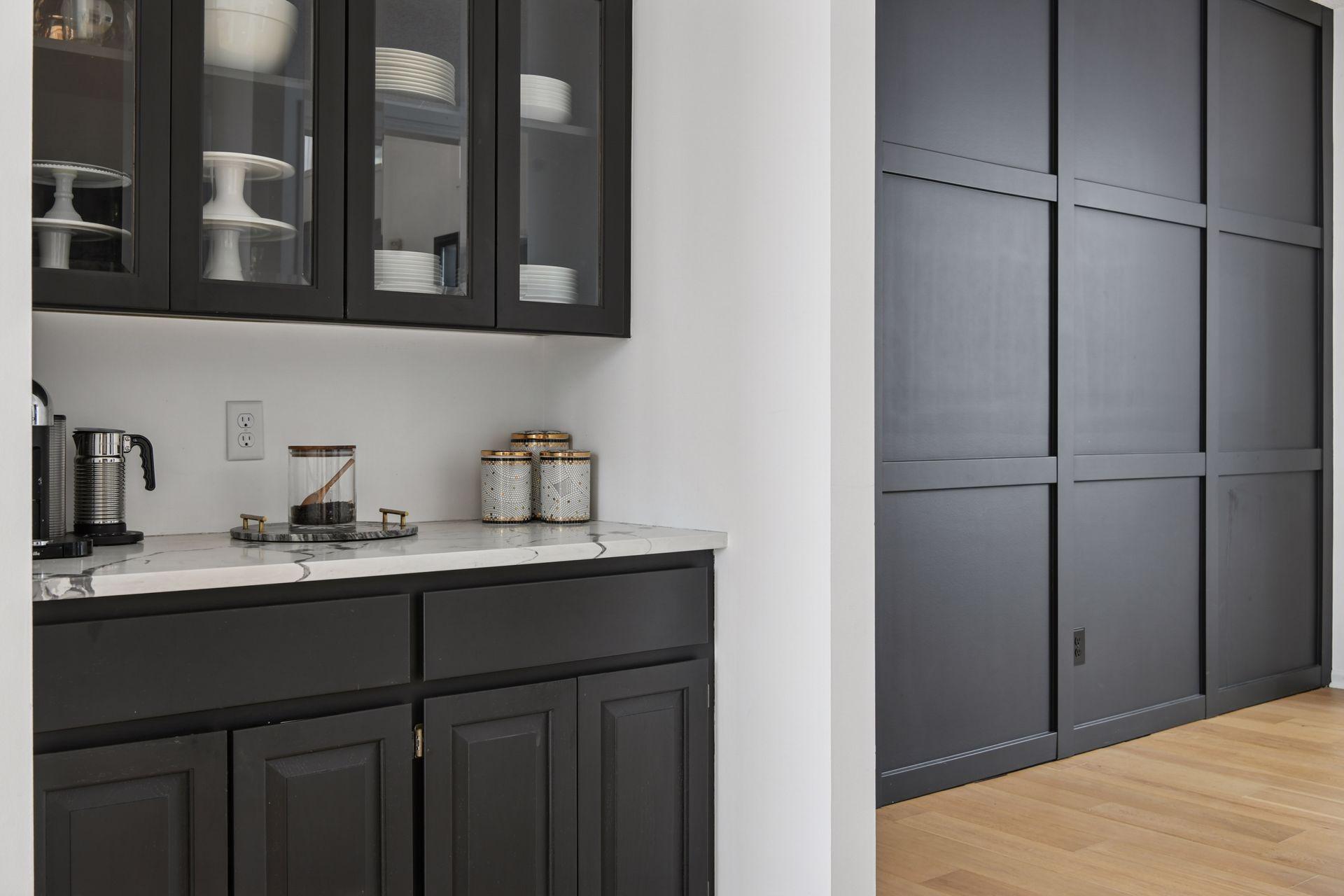 Coffee bar and accent wall elevate this formal dining Butler's pass through to the great room.