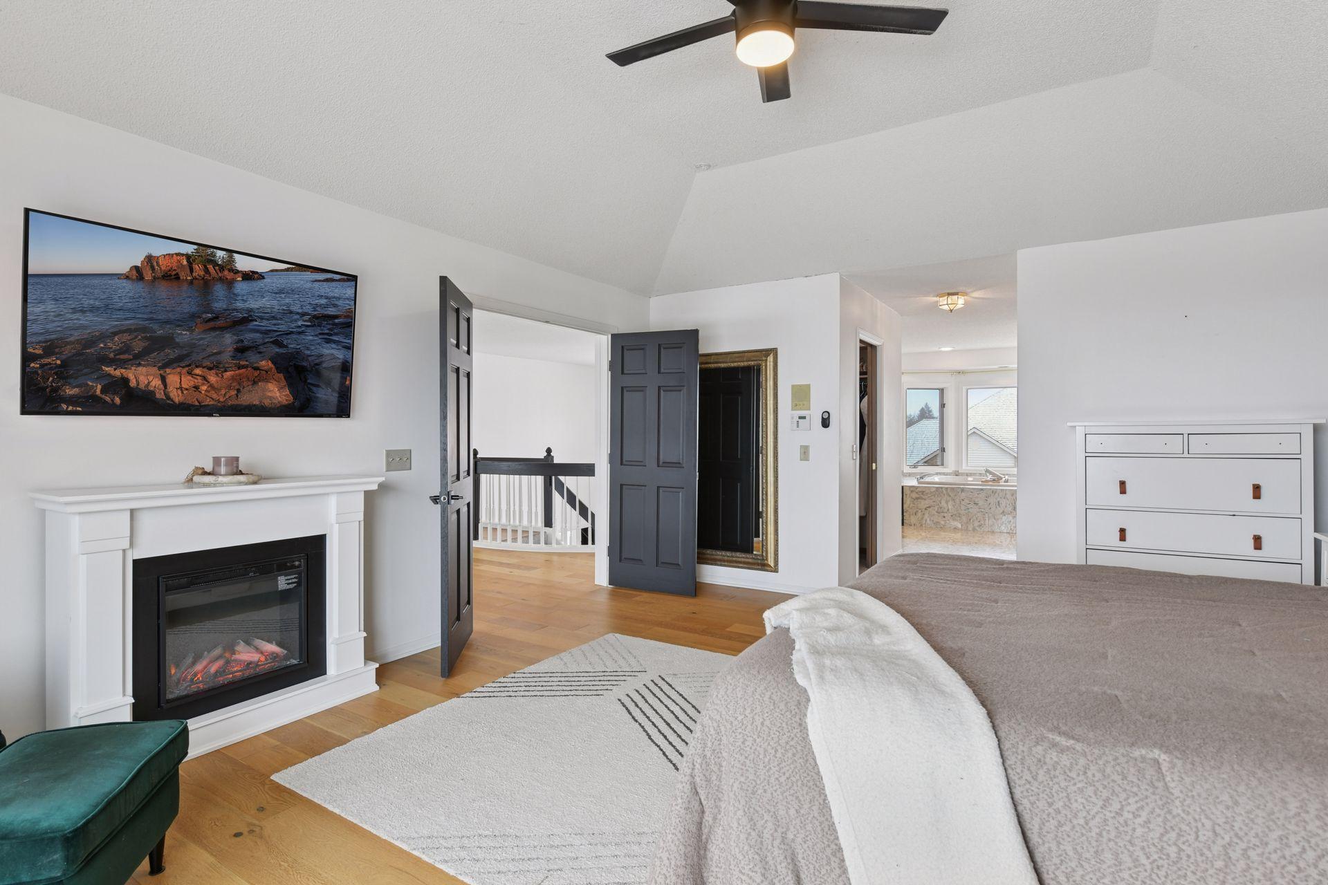 Elegant double doors create a grand and intentional entrance into the primary suite sanctuary.