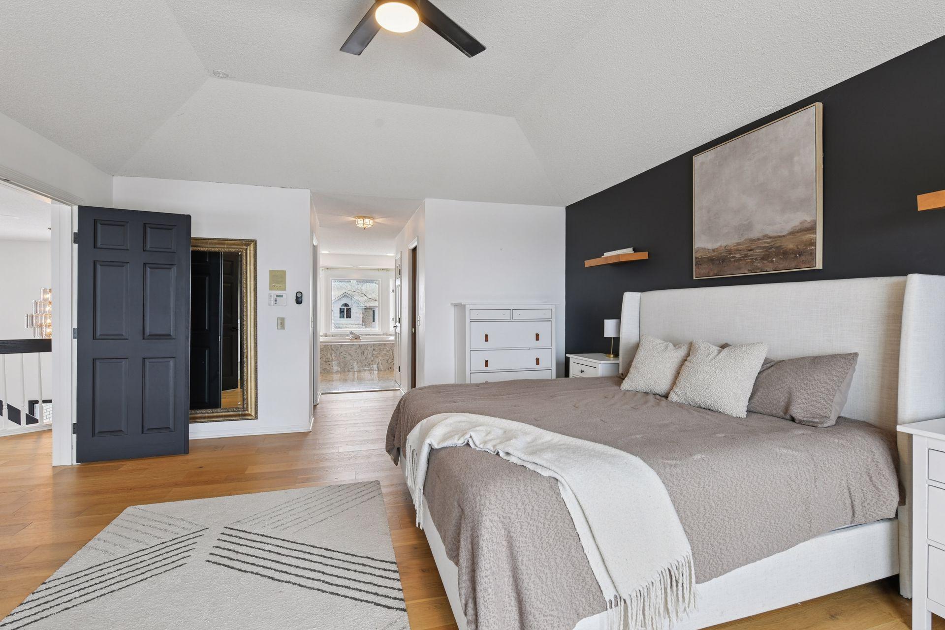 Custom-designed closets with updated flooring provide elevated storage and thoughtful functionality.