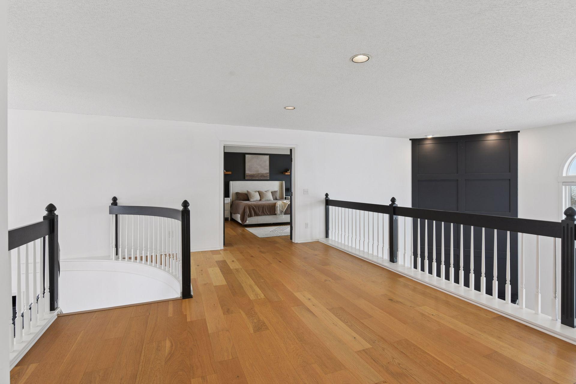 A versatile loft overlooking the living spaces below — perfect for a secondary lounge, reading retreat, workspace, or creative studio.