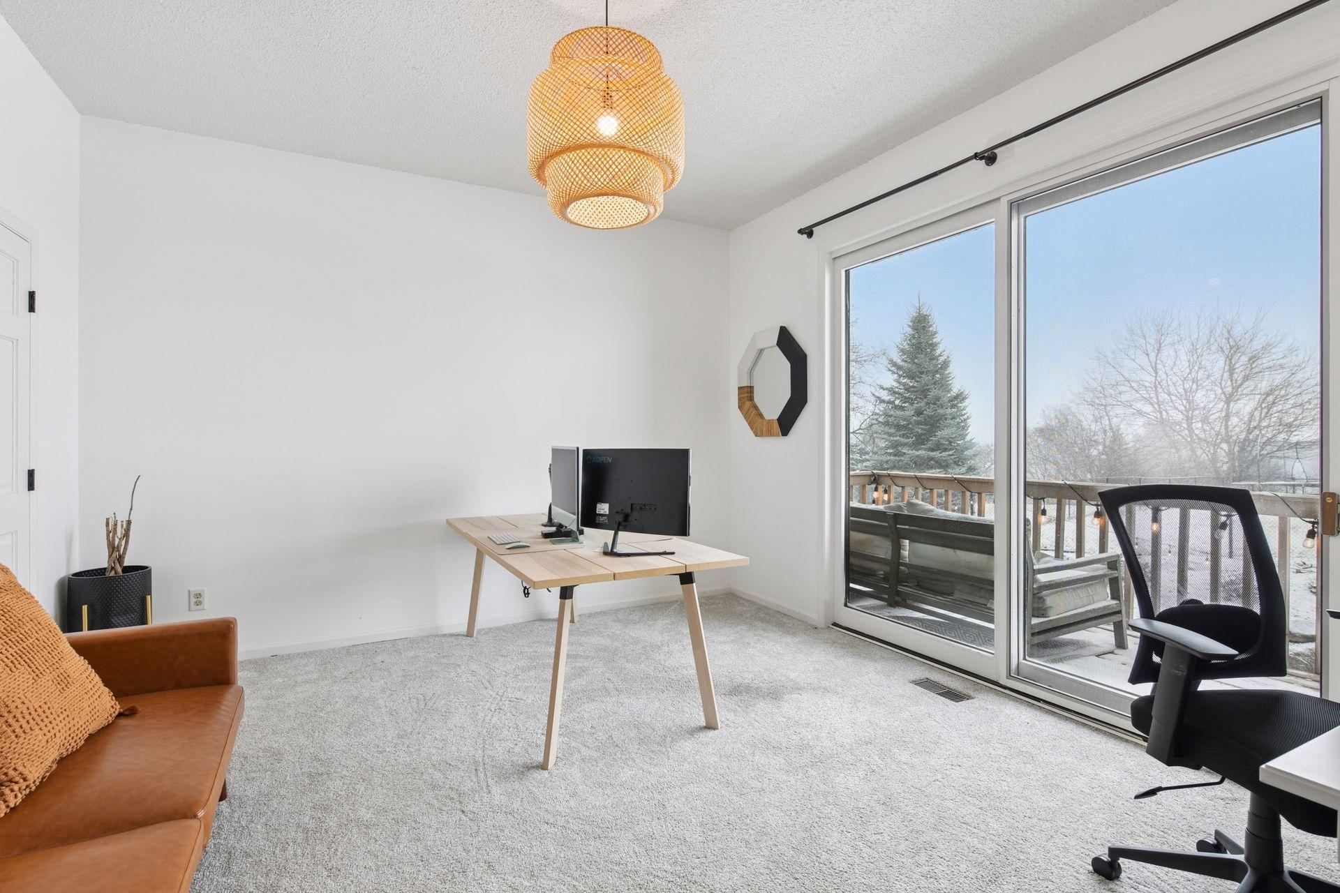 Main level fifth bedroom guest suite or office with private balcony & adjacent 3/4 beautifully tiled bathroom