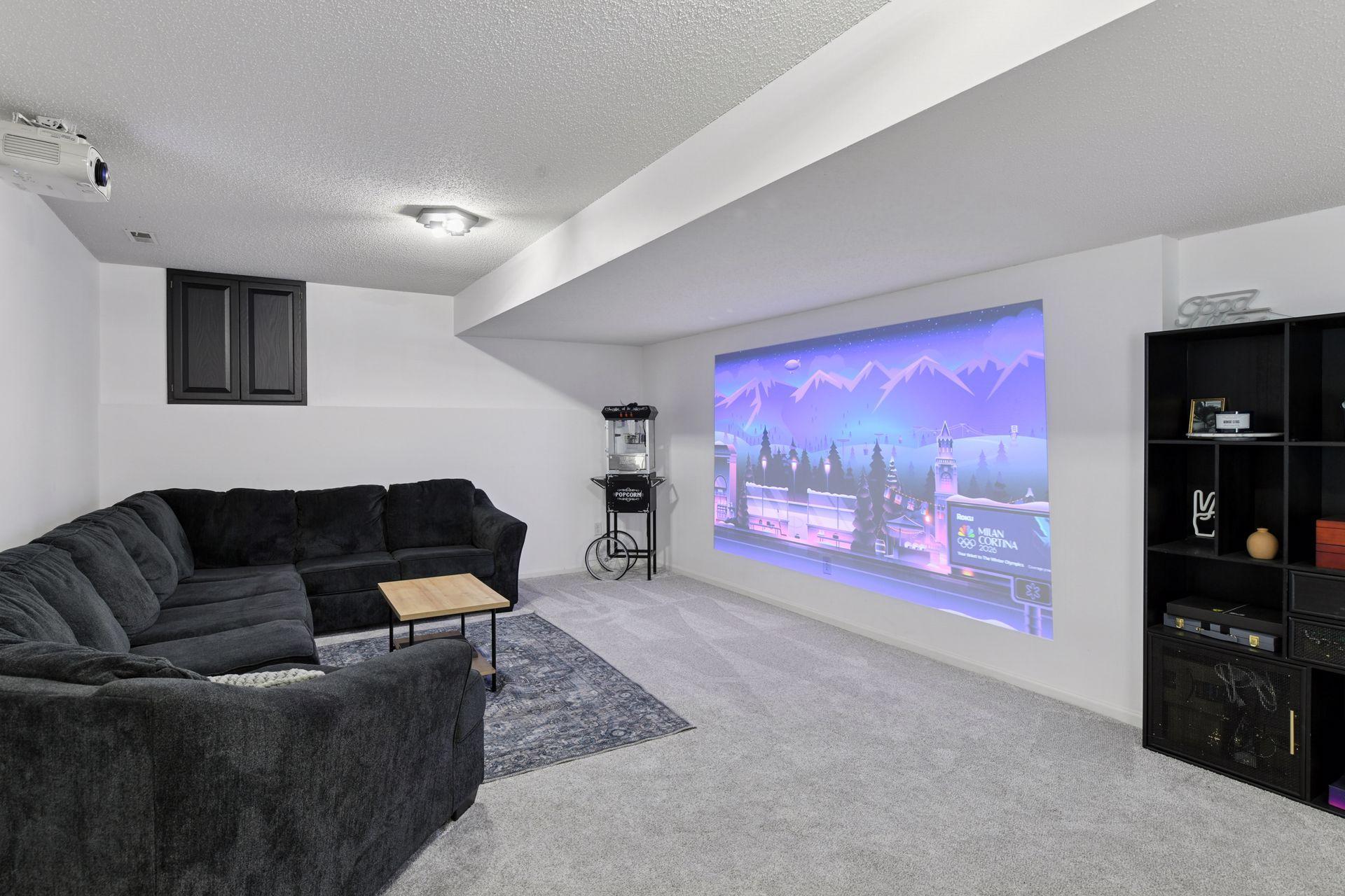 Lights Down. Volume Up. A cozy movie viewing space completes the lower level — perfect for cinematic evenings at home.