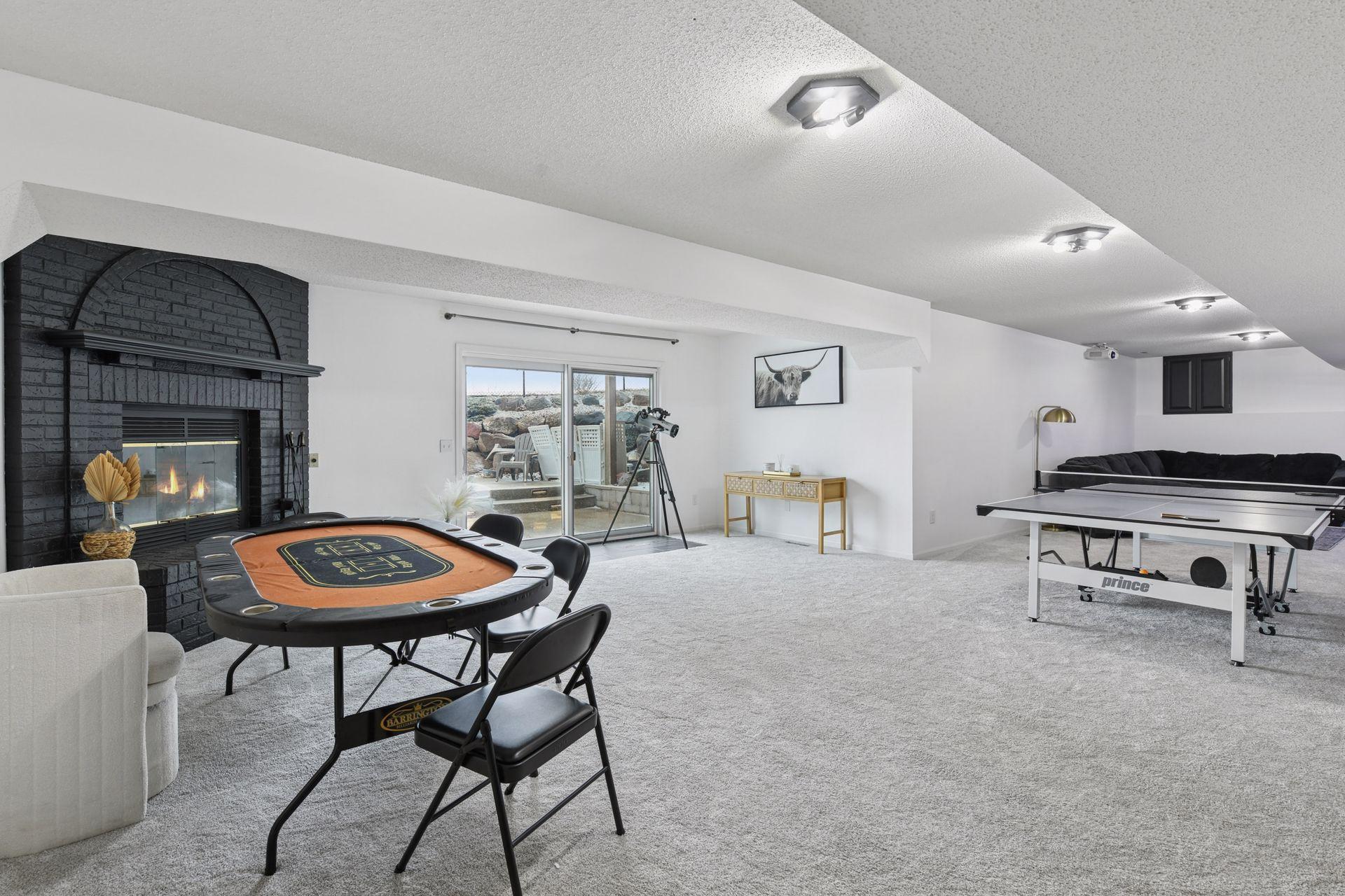 An enormous walk-out lower level offering multiple curated spaces for recreation, relaxation, and effortless indoor-outdoor flow.