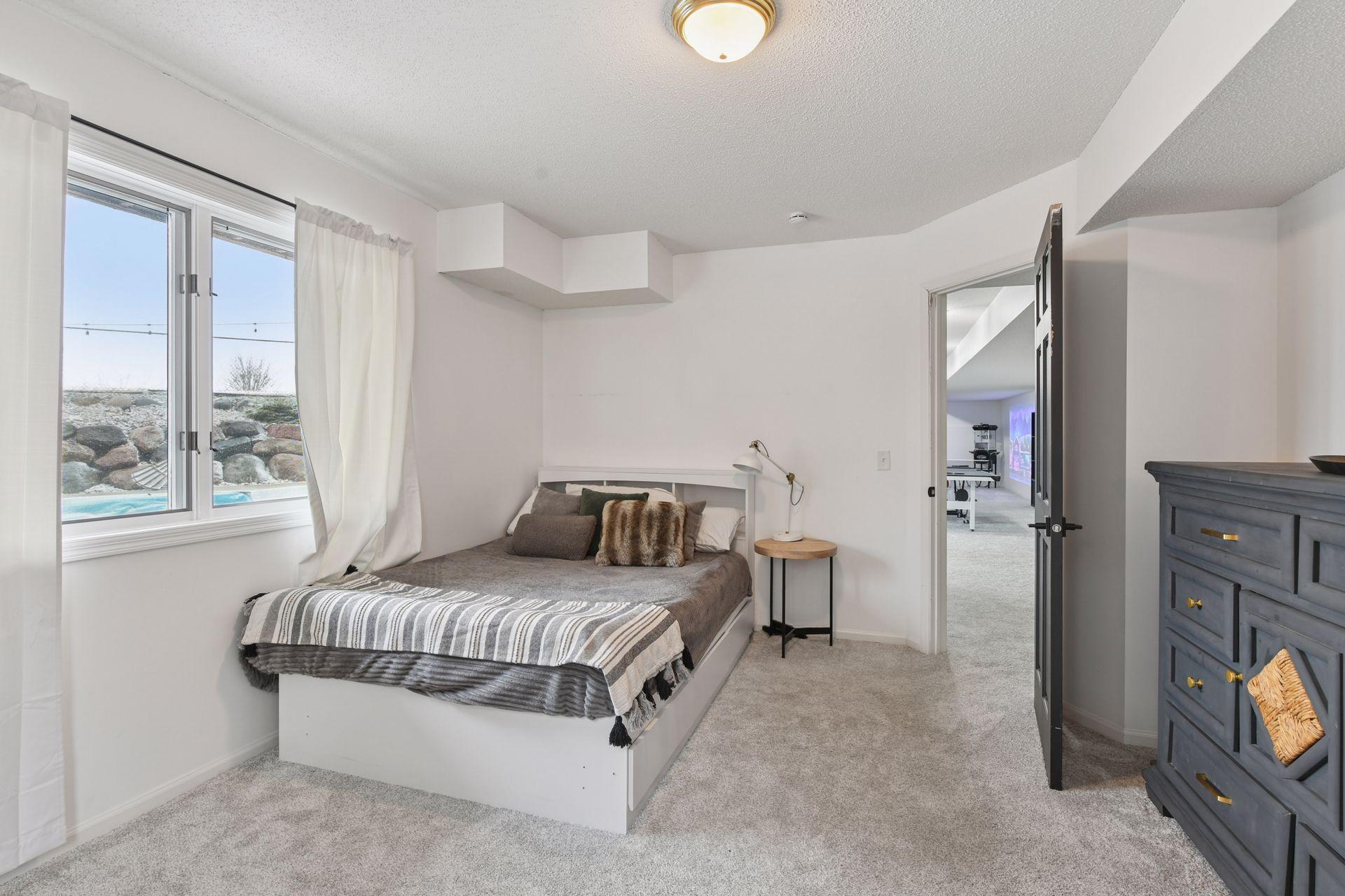 Sixth, lower level bedroom with enormous closet, adjacent bathroom and spectacular view of the pool deck & back yard.