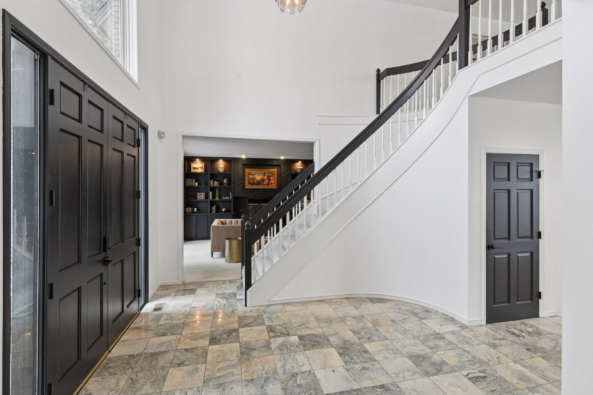 A dramatic spiral staircase anchors the interior, adding movement, artistry, and timeless elegance to the home’s design.