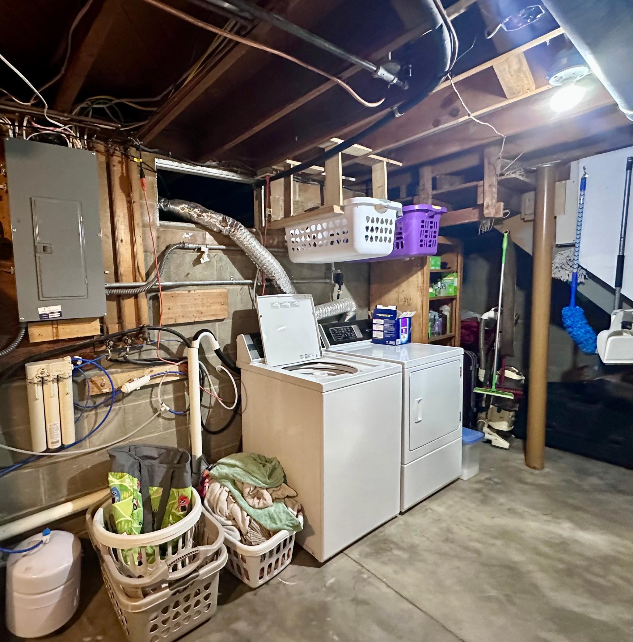 Mechanical/Laundry room offers more built-ins for laundry baskets above the laundry hookups.