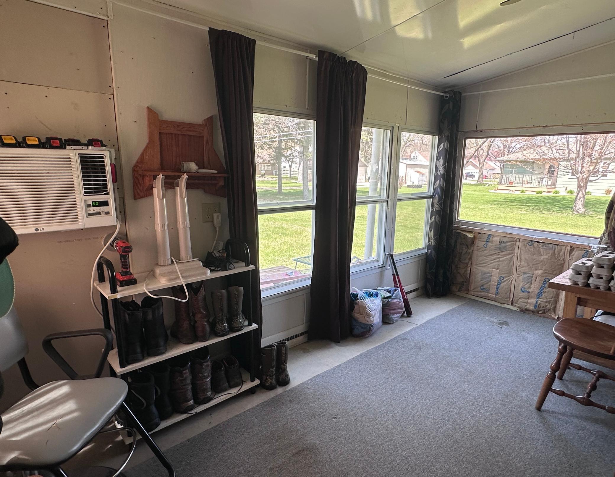 Back up the stairs is a door accessing this 4-season porch area -- mini-split unit 2019/2020 installed.