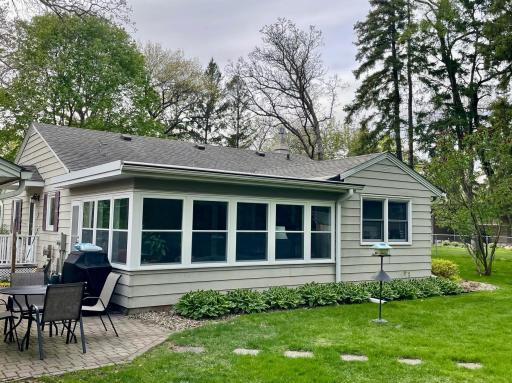 Exterior view of three season porch and backyard patio area