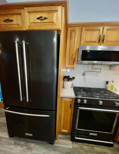 Black stainless steel appliances in kitchen all to stay, pot filler water spout over stove top