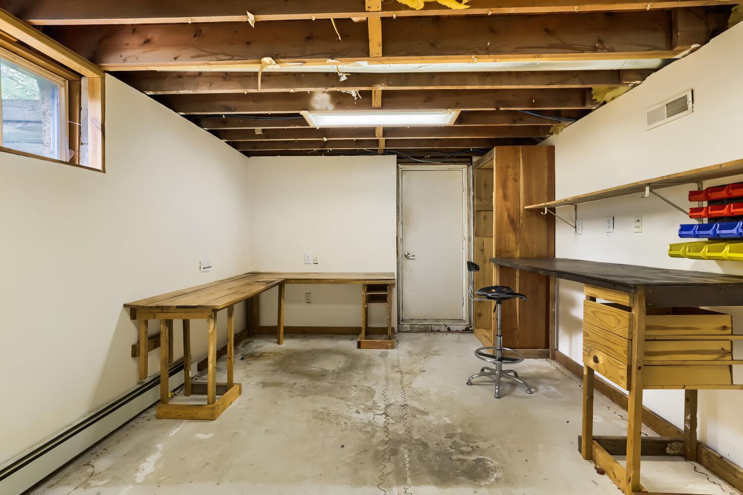 This could be made into a legal 4th bedroom. It has an exit door leading to the south side yard. previously used as a workspace.