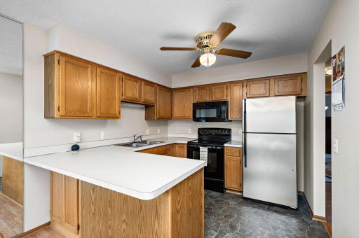 The kitchen has plenty of cabinetry and counter space including a breakfast bar!