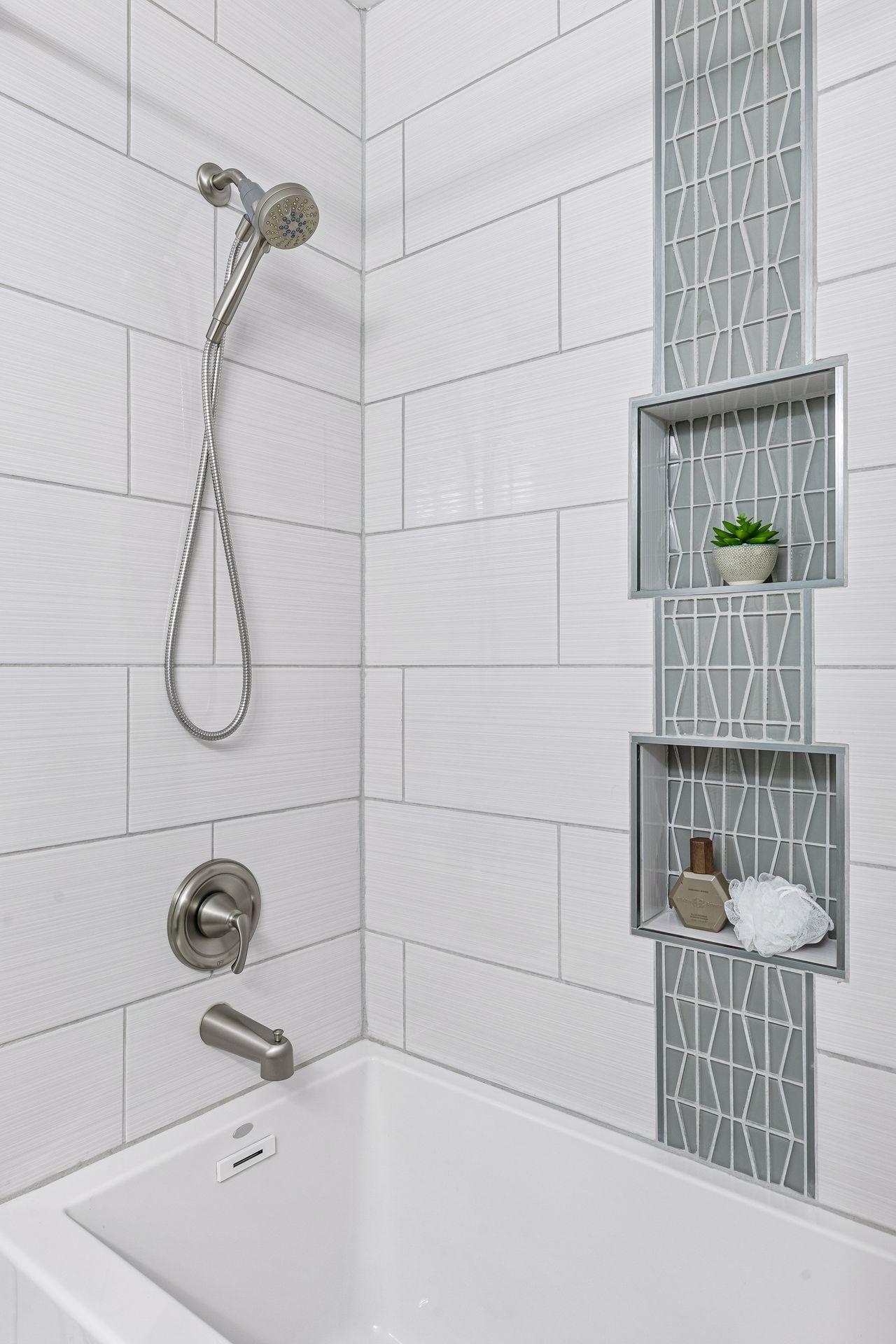Updates to main level full bath also include a soaker tub and stunning tile work.