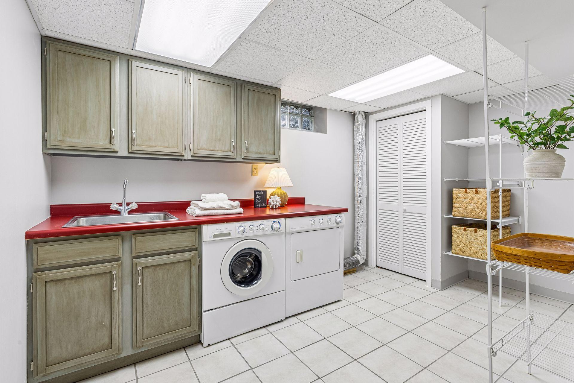 Laundry room has lots of storage, and space for laundry baskets and folding.