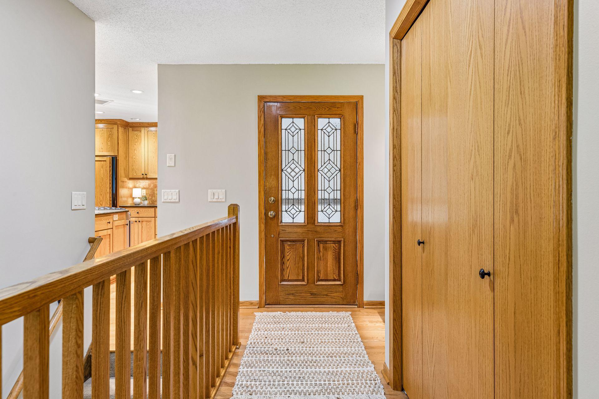 Stunning front entry with hardwood floors and custom railings.