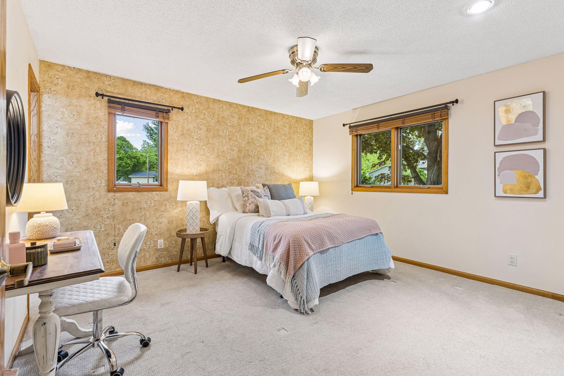 Spacious primary bedroom with new carpet and lots of natural light.