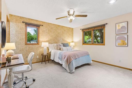 Spacious primary bedroom with new carpet and lots of natural light.