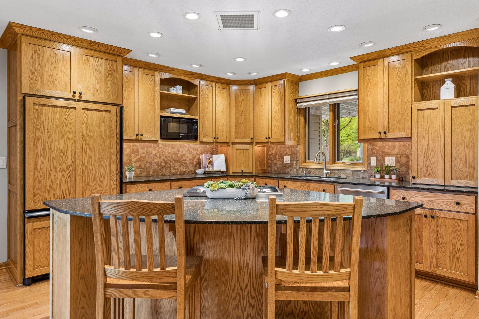 Granite counters, refrigerator panels that match the cabinetry, deep drawers for dishes, and stainless steel appliances are just a few of the many great features of this kitchen.