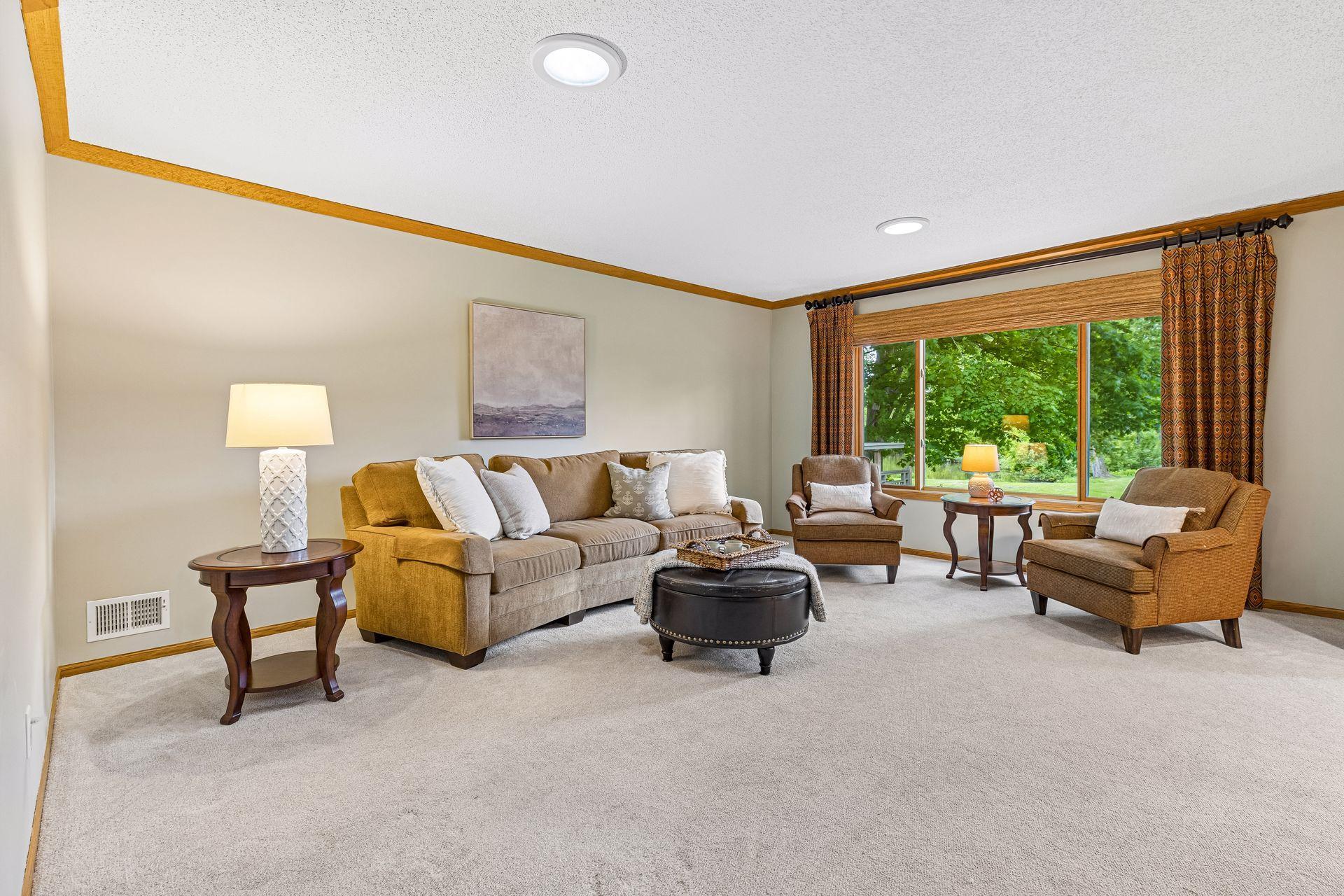 Spacious living room with new carpet and a stunning pond view.