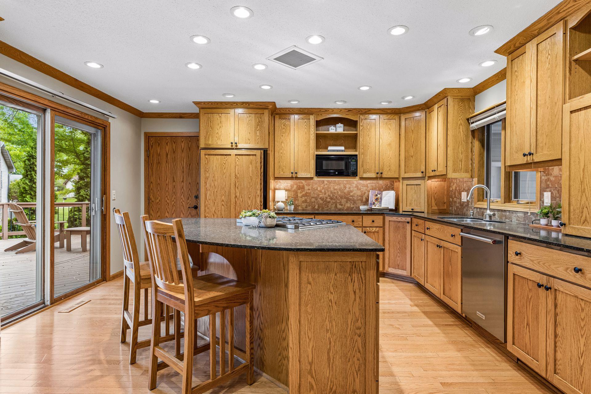 Kitchen/dining area flows onto the expansive deck with a view of the pond.
