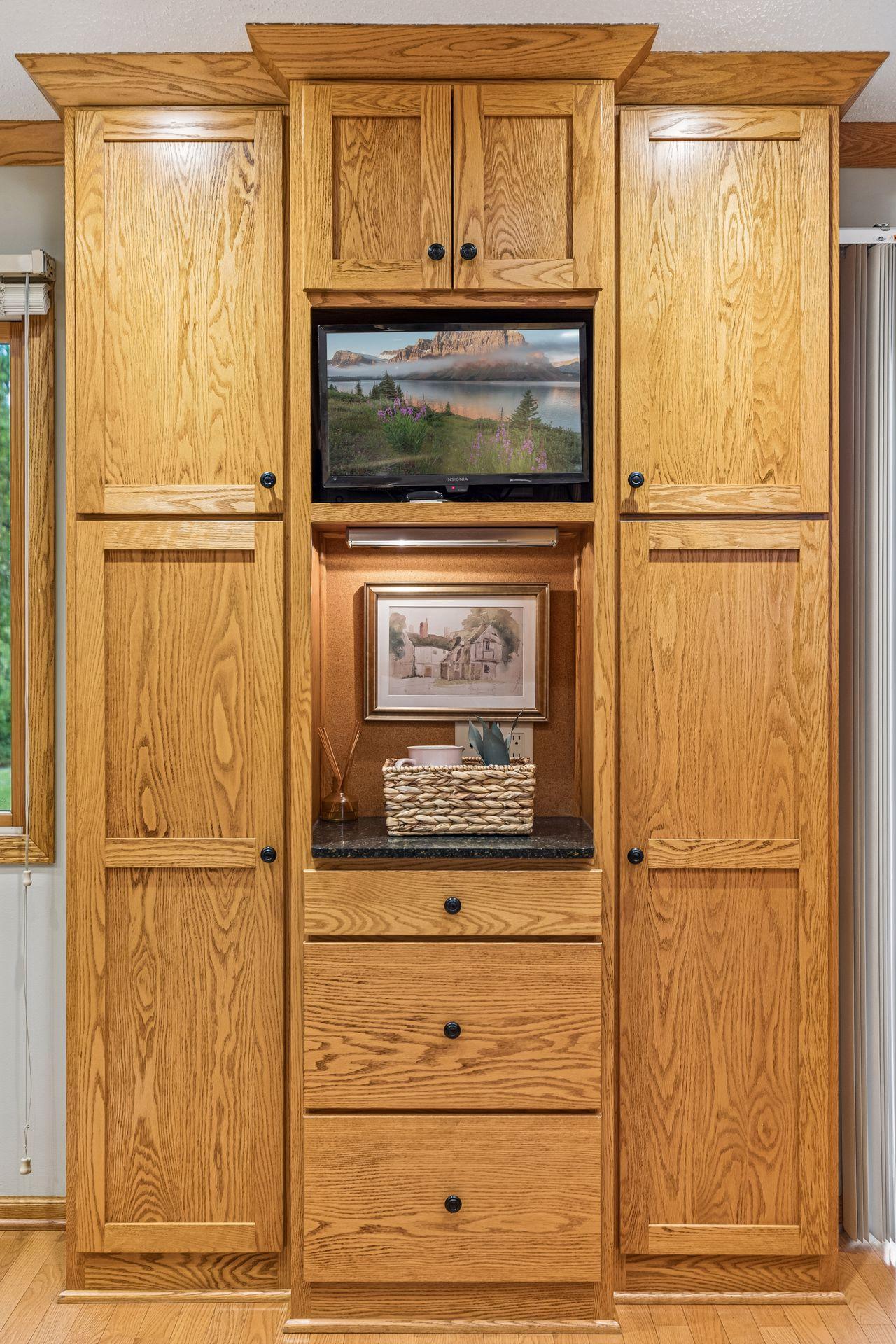 Convenient pantry cabinetry and space for a tv and electronic calendar make staying organized a breeze.