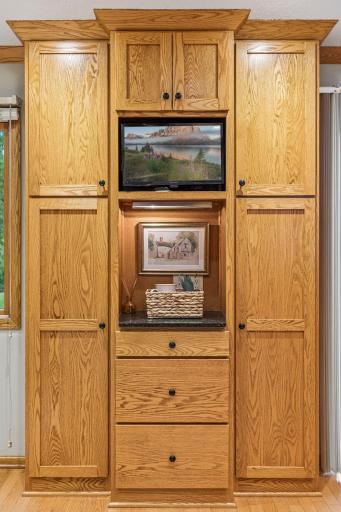Convenient pantry cabinetry and space for a tv and electronic calendar make staying organized a breeze.