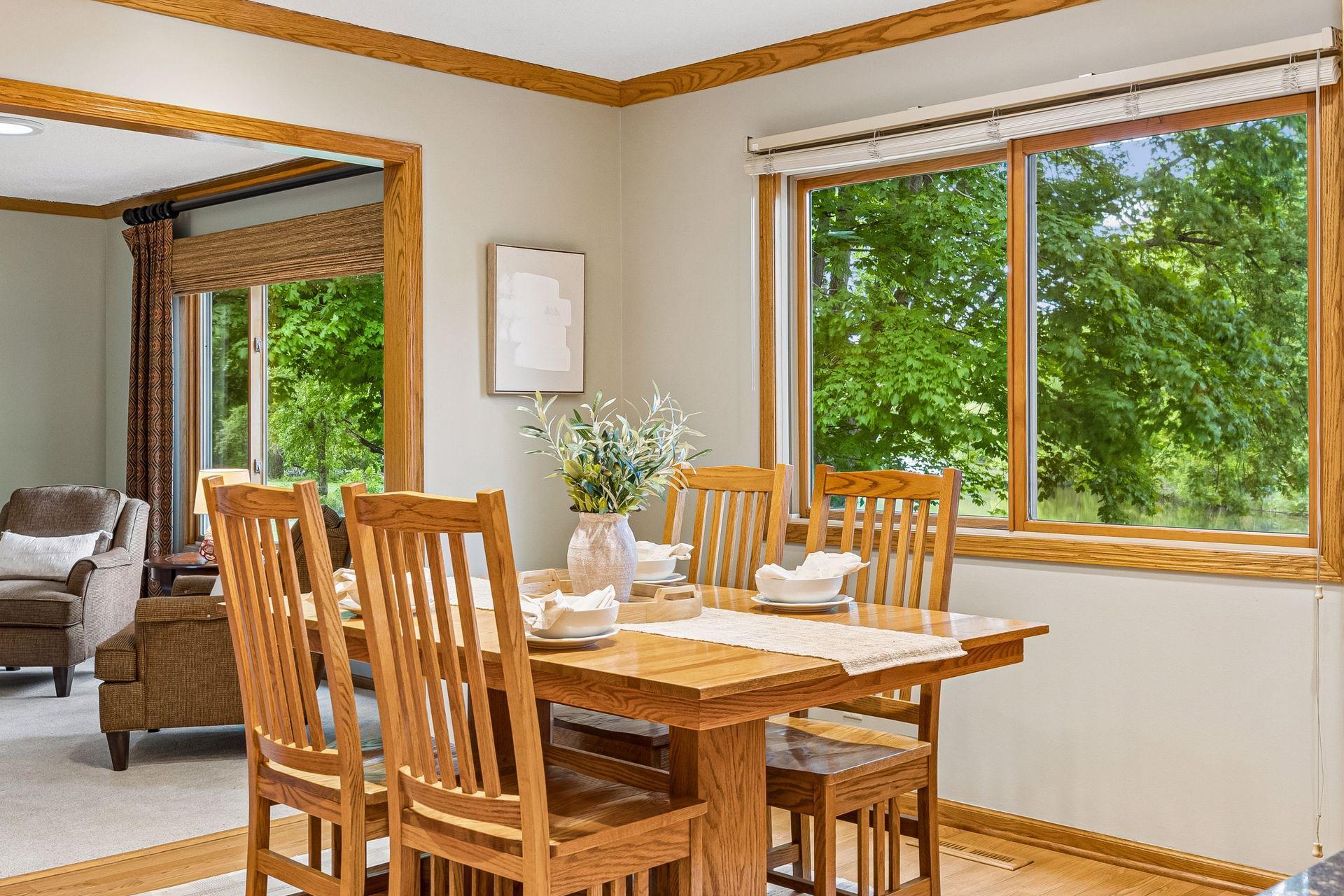 A stunning pond view serves as a backdrop to the lovely dining area.