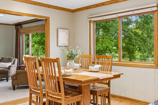 A stunning pond view serves as a backdrop to the lovely dining area.