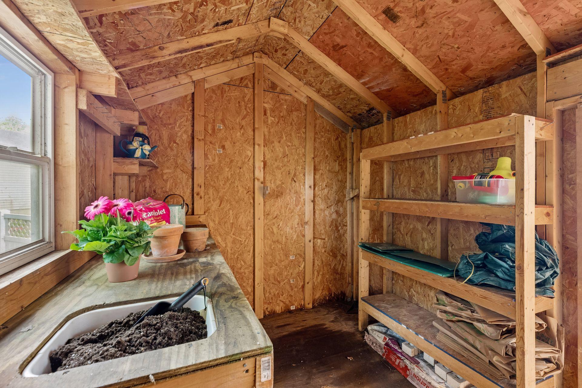 A charming shed is a great space for a potting shed or playhouse complete with its own fenced in space.