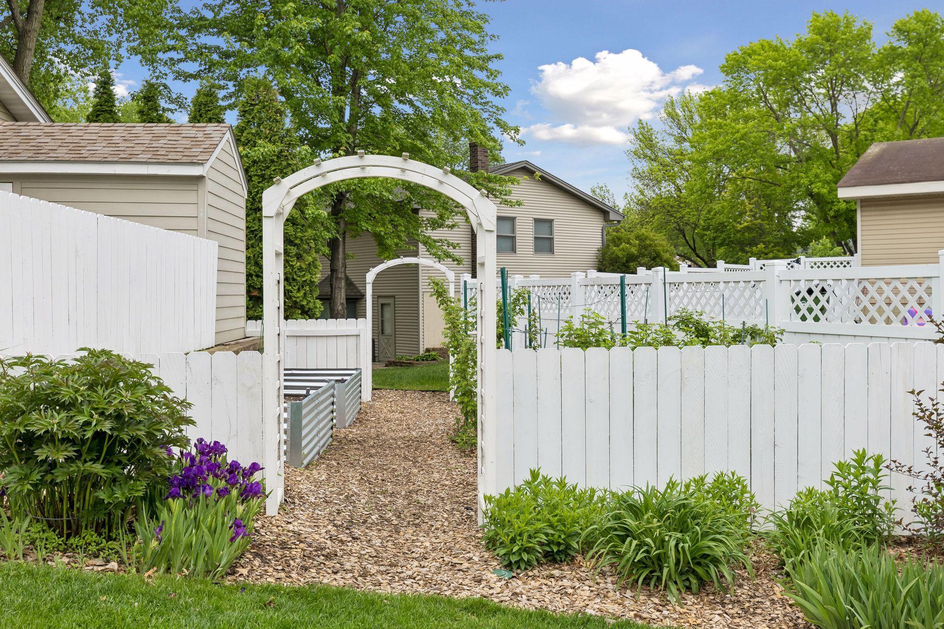 The beautifully landscaped yard includes a space for gardening with raised garden beds complete with it's own watering system. Could be converted to private firepit or patio space.