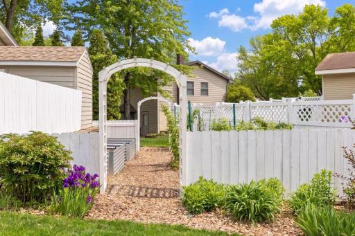 The beautifully landscaped yard includes a space for gardening with raised garden beds complete with it's own watering system. Could be converted to private firepit or patio space.