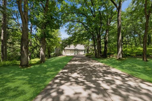 Estate-Like Setting, tucked away at the end of a quiet street, this custom Michels Homes rambler is surrounded by 3.61 acres overlooking a beautiful pond, offering exceptional privacy and timeless appeal.