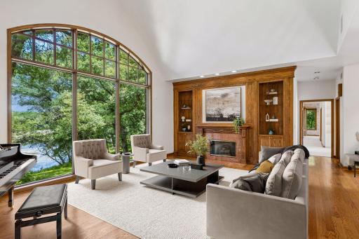 Panoramic Pond Views, the dramatic arched picture window frames breathtaking pond views, while custom built-ins and a gas fireplace create a warm and inviting gathering space. Virtual Staging