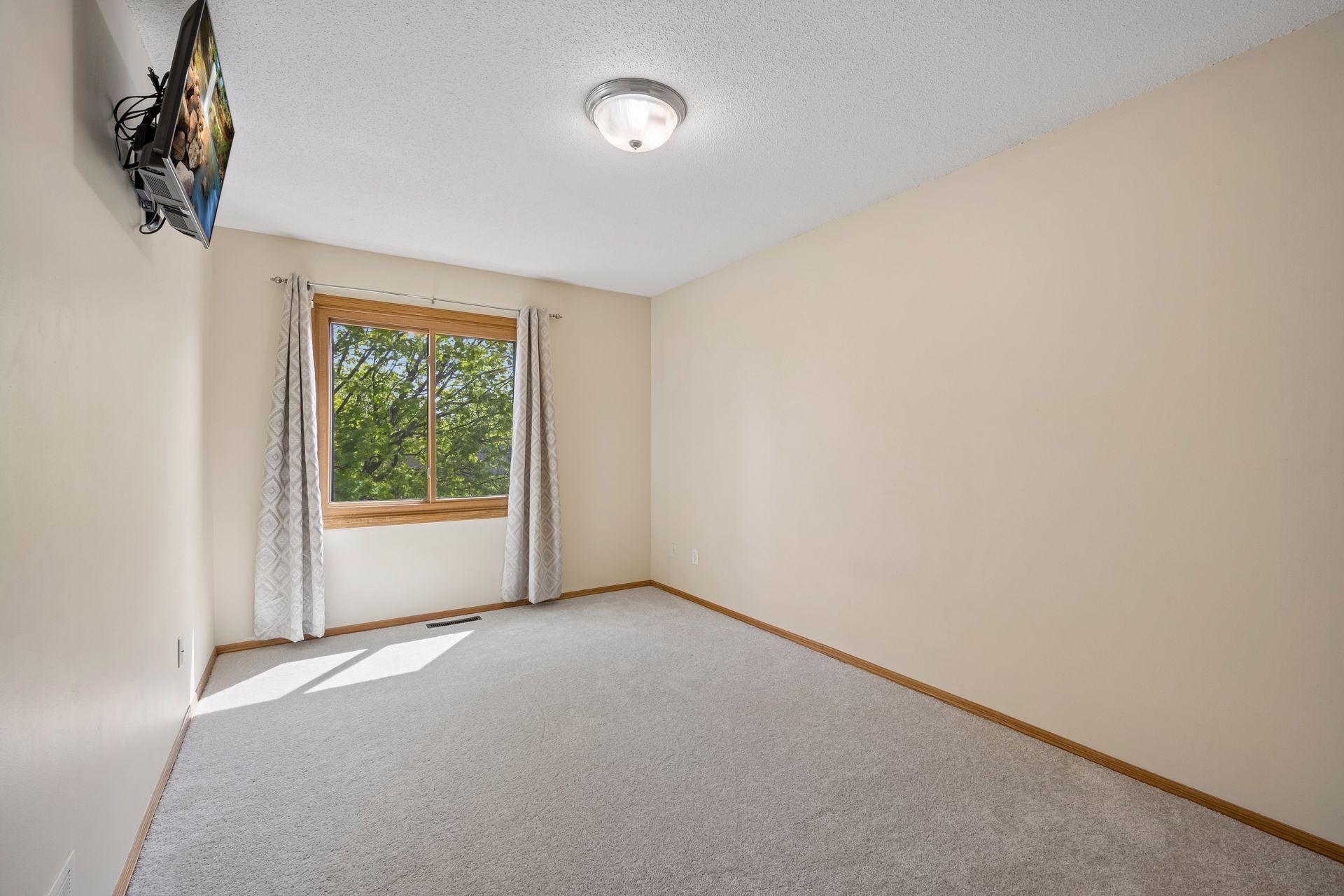 Upper bedroom on the right as you go down the hallway with large window overlooking the maple tree
