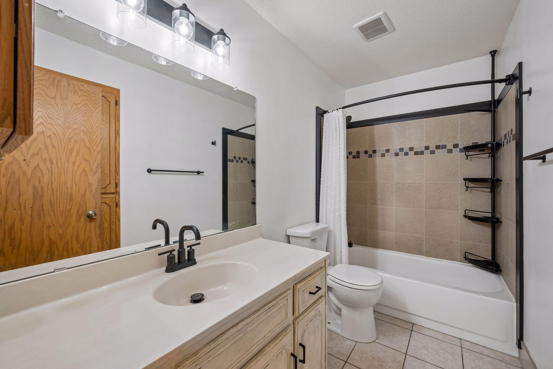 Upper bathroom with new tub surround and fixtures in 2025