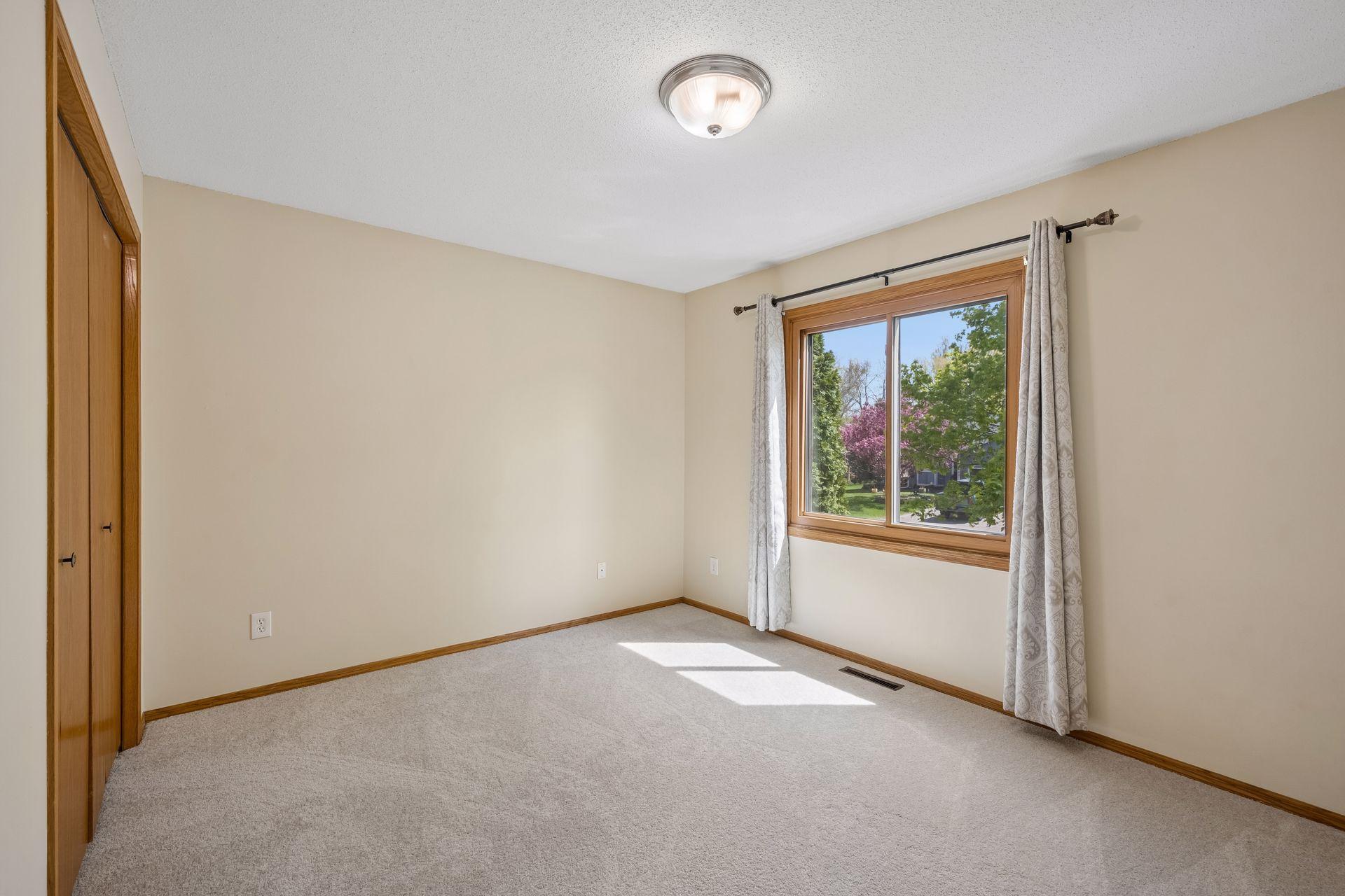 Upper bedroom on left with another great view of the beautiful maple tree out the window