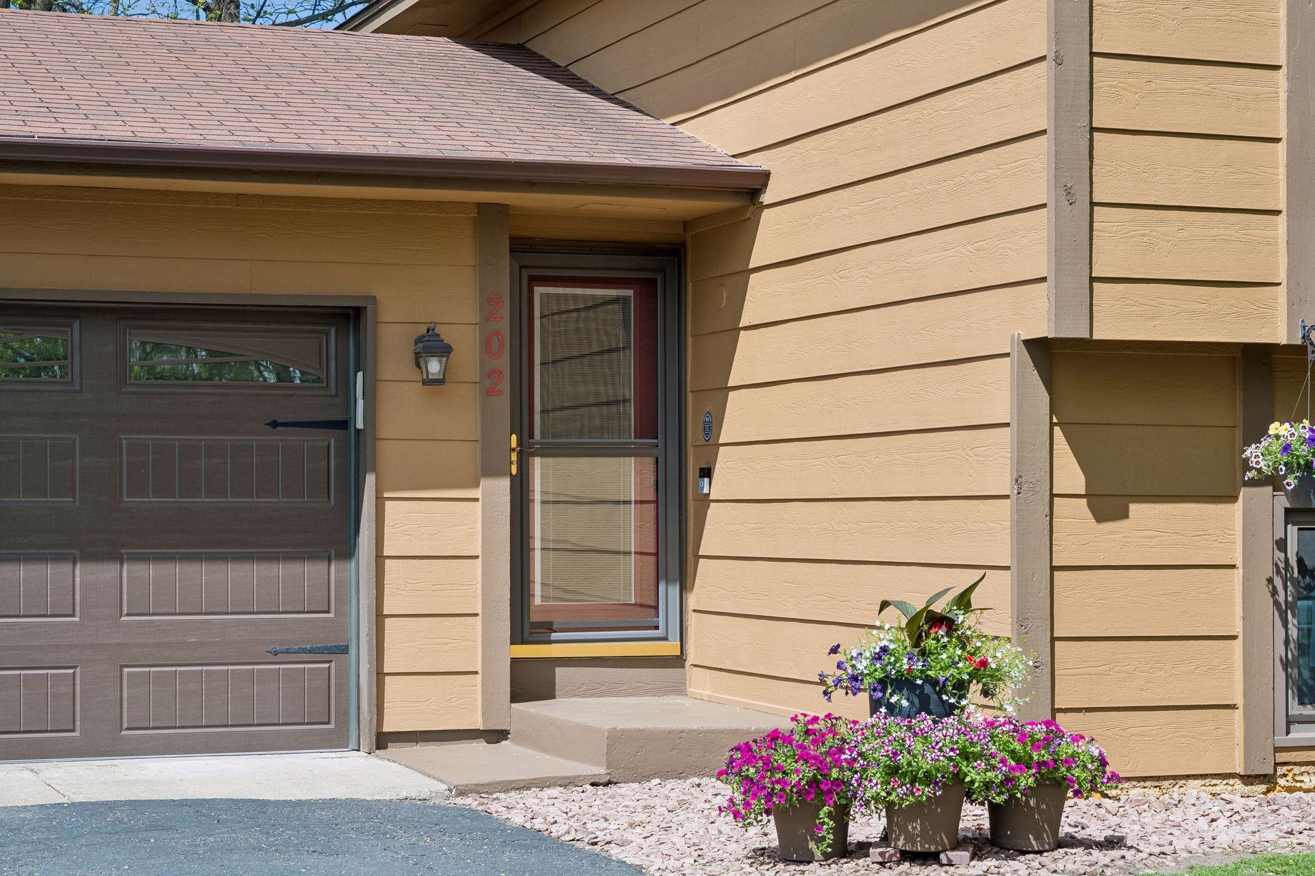 Front entrance with new overhead garage door installed 2024