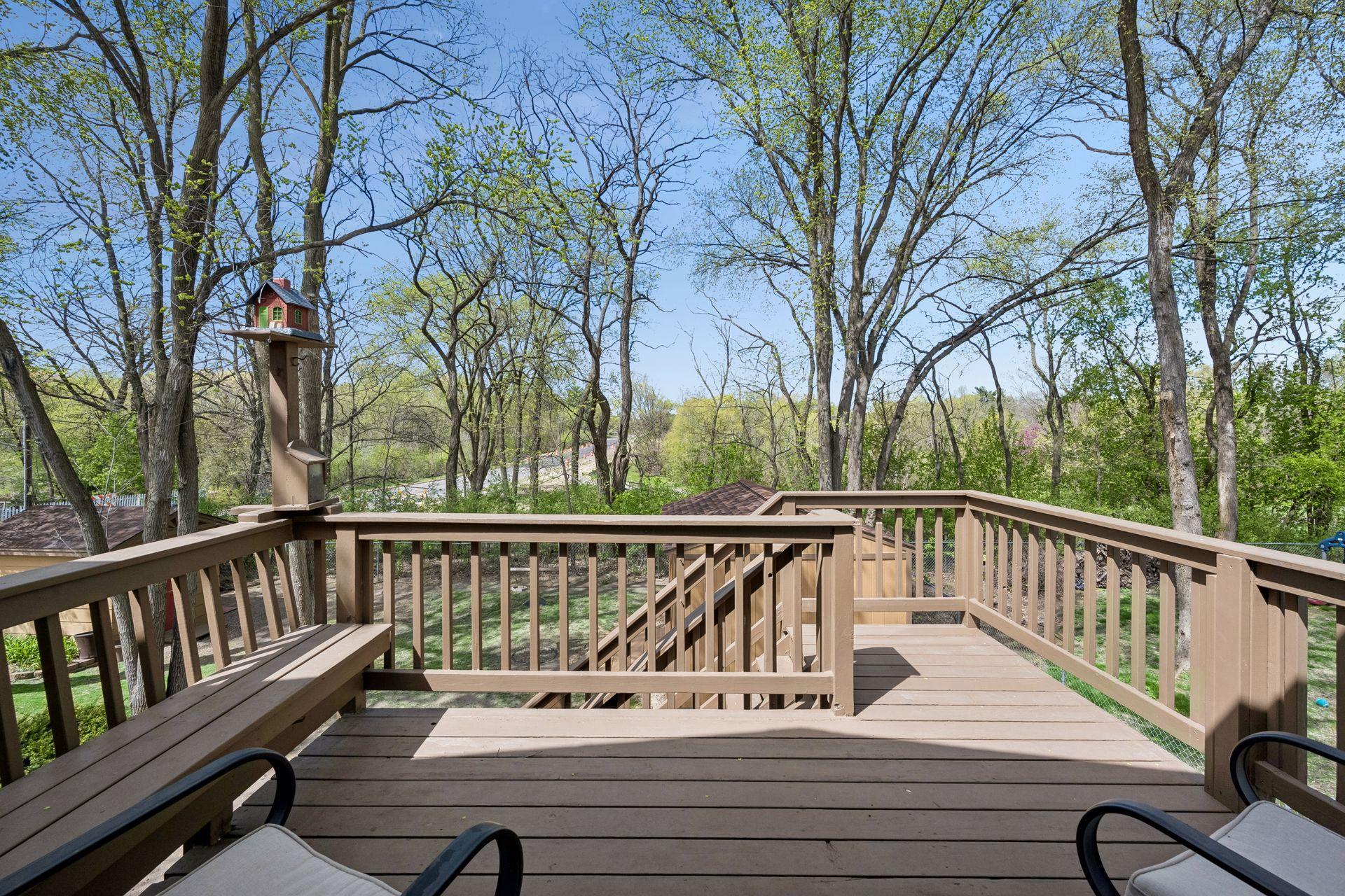 Deck overlooking corner lot with mature trees