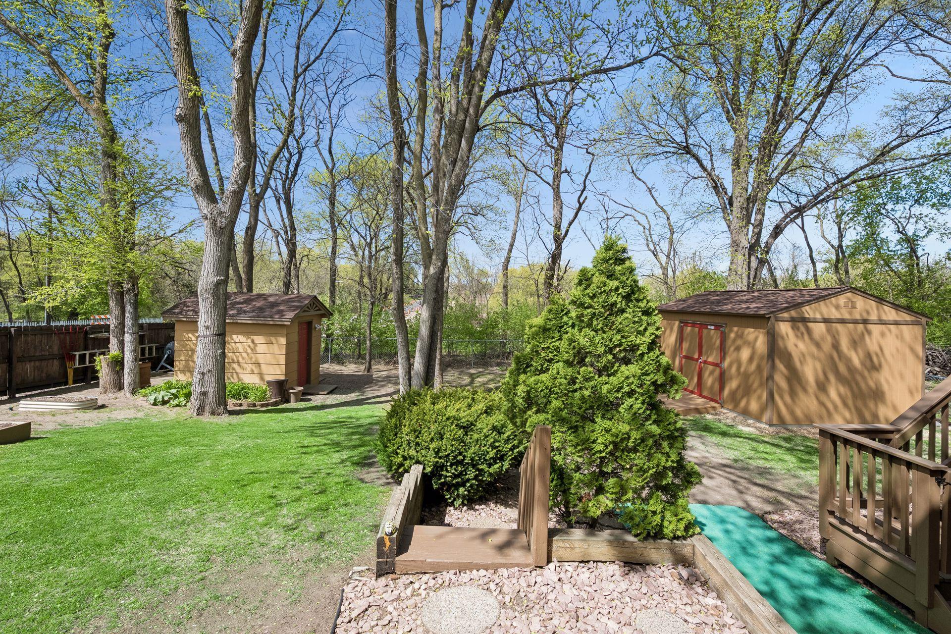 Backyard showing both sheds and stairway to deck